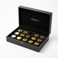 Matte black luxury box open with velvet insert holding gold coins and gold bar